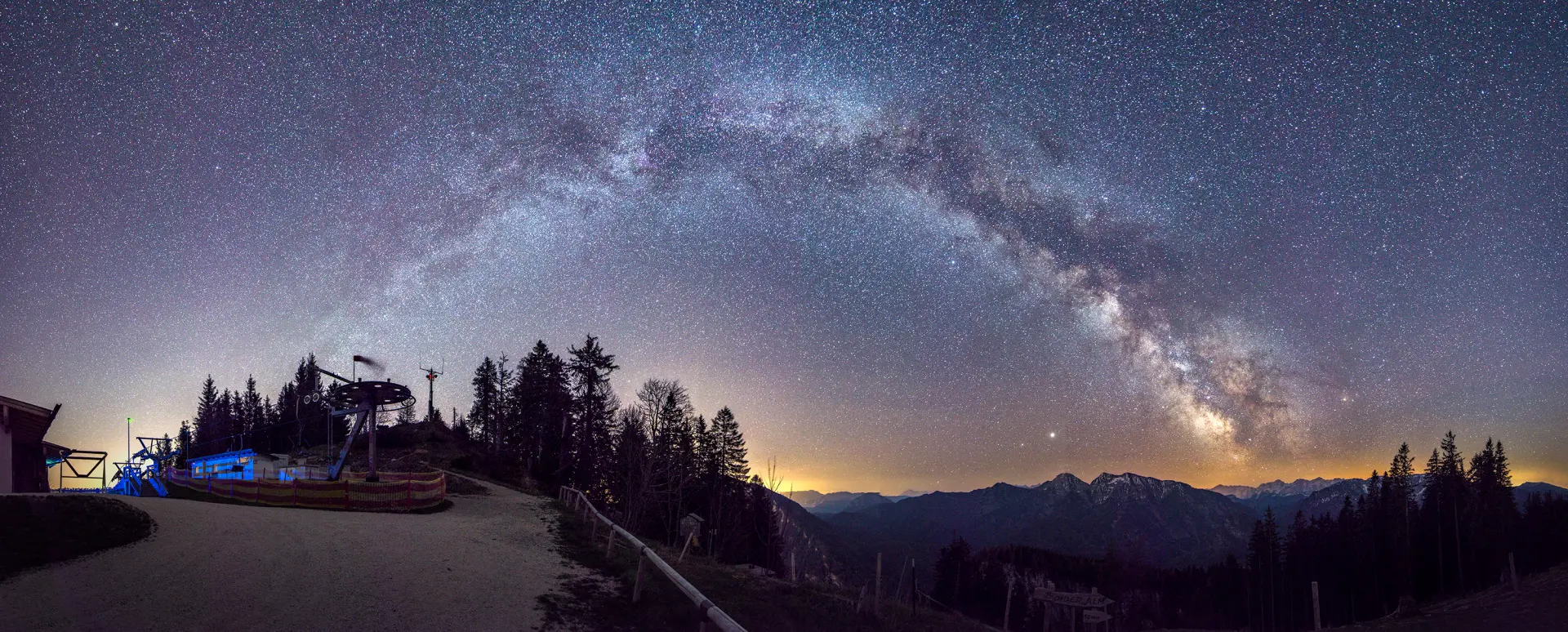 Nachthimmel mit Milchstraße über Berglandschaft und Sternenfotografie-Equipment als Motiv für Berg- und Nachtfotografie-Kurs