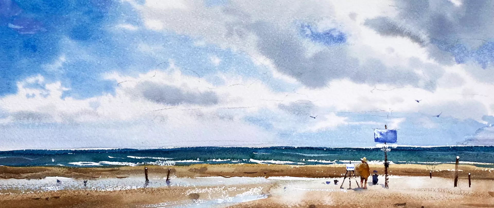 Weite Strandlandschaft in Aquarell mit Meer, blauem Himmel und Malerin im Vordergrund - atmosphärische Küstenszene - von artistravel Dozentin Barbara Hirsekorn