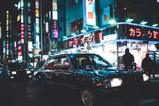Neonlichter fotografieren lernen im Fotokurs oder Fotoworkshop. Foto: Jon Tang/Unsplash. Fotografie einer Straße bei Nacht in einer Großstadt.