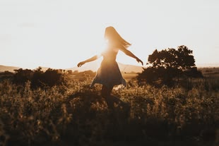Wie nutze ich das Licht für meine Fotografie? Experimentieren und Fotografieren lernen. Foto: Jackson David/Unsplash. Fotografie einer Frau in einer Landschaft.